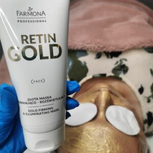 face with a gold cream on, reting gold product package